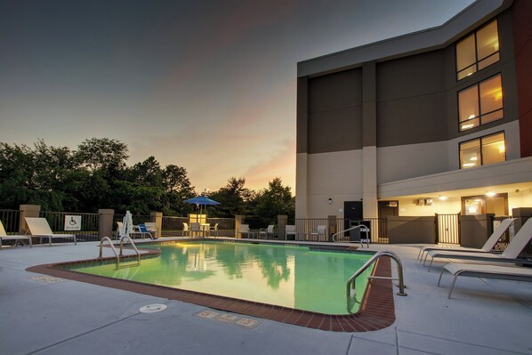 A swimming pool area with lounge chairs and a lifeguard stand. - Holiday Inn Express Voorhees - Mt. Laurel  by IHG (Voorhees)