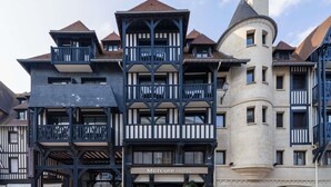 A hotel with a traditional European architectural style, featuring multiple balconies, a prominent tower, and a sign indicating it is the Mercure Hotel. - Mercure Deauville Centre (Deauville)