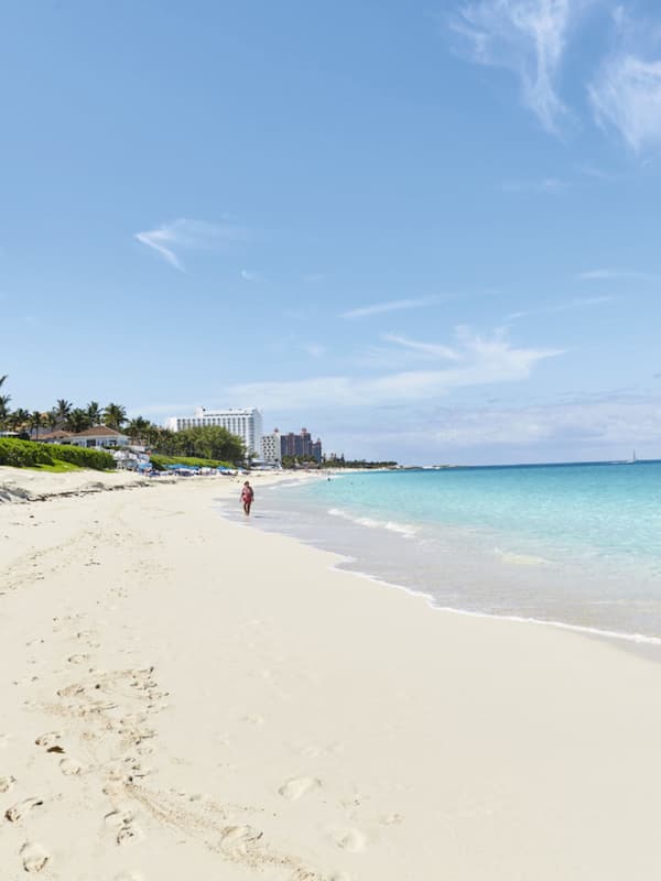 On the beach, white sand, sun loungers, beach towels