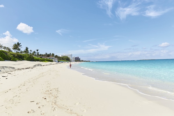 On the beach, white sand, sun-loungers, beach towels