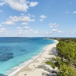 On the beach, white sand, sun loungers, beach towels