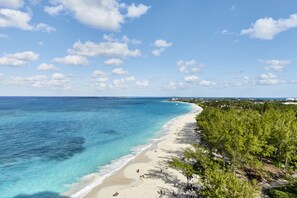 On the beach, white sand, sun loungers, beach towels