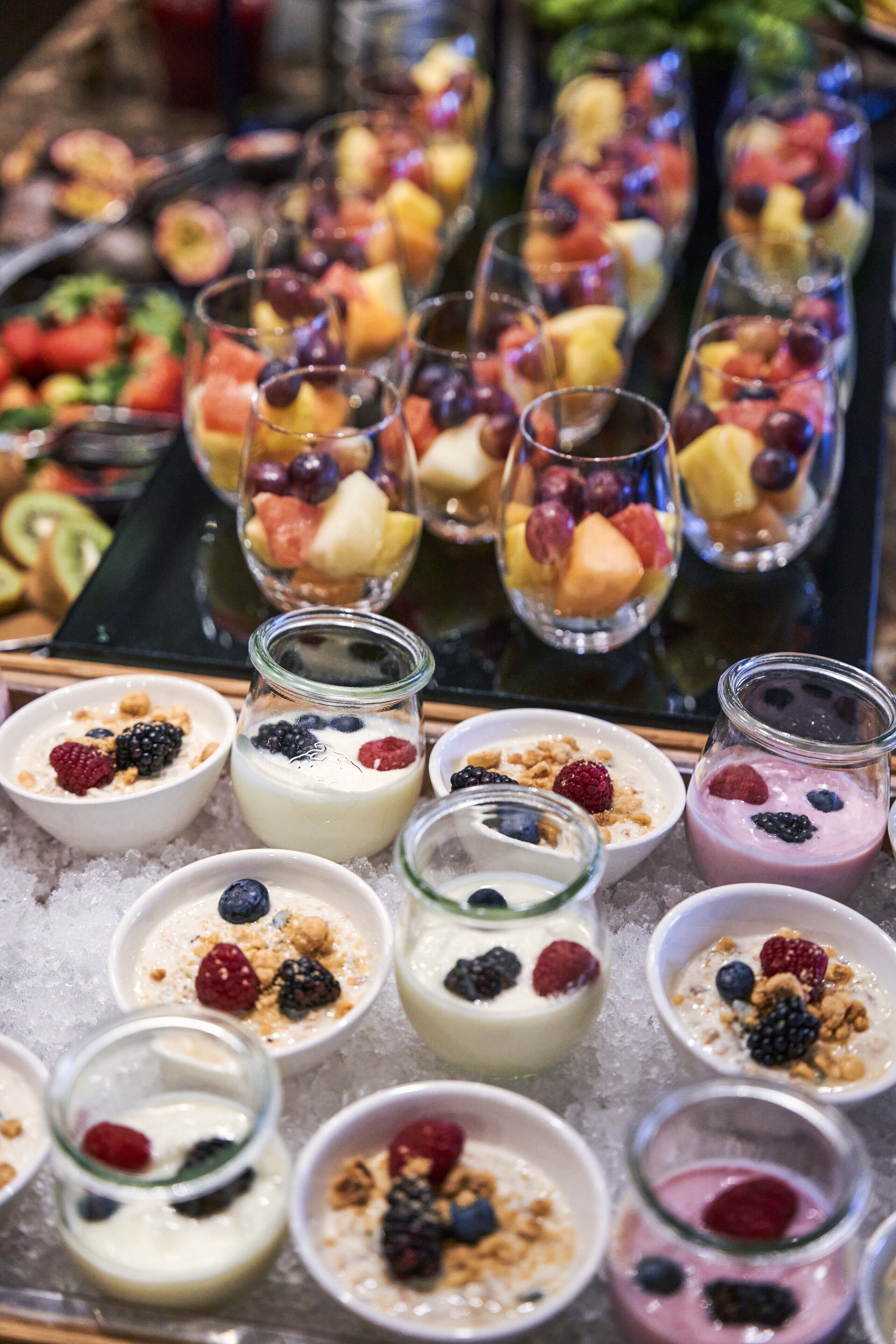 A variety of desserts and fruits arranged on a tray.