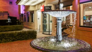 A fountain in an outdoor area with a building in the background. - ibis Besancon Centre Ville (Besancon)