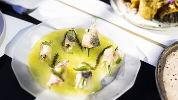 A plate of food with various seafood items and green garnish.