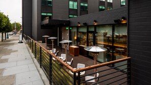 A modern restaurant with outdoor seating and a prominent sign. - Kimpton Alton Fisherman's Wharf by IHG (San Francisco)