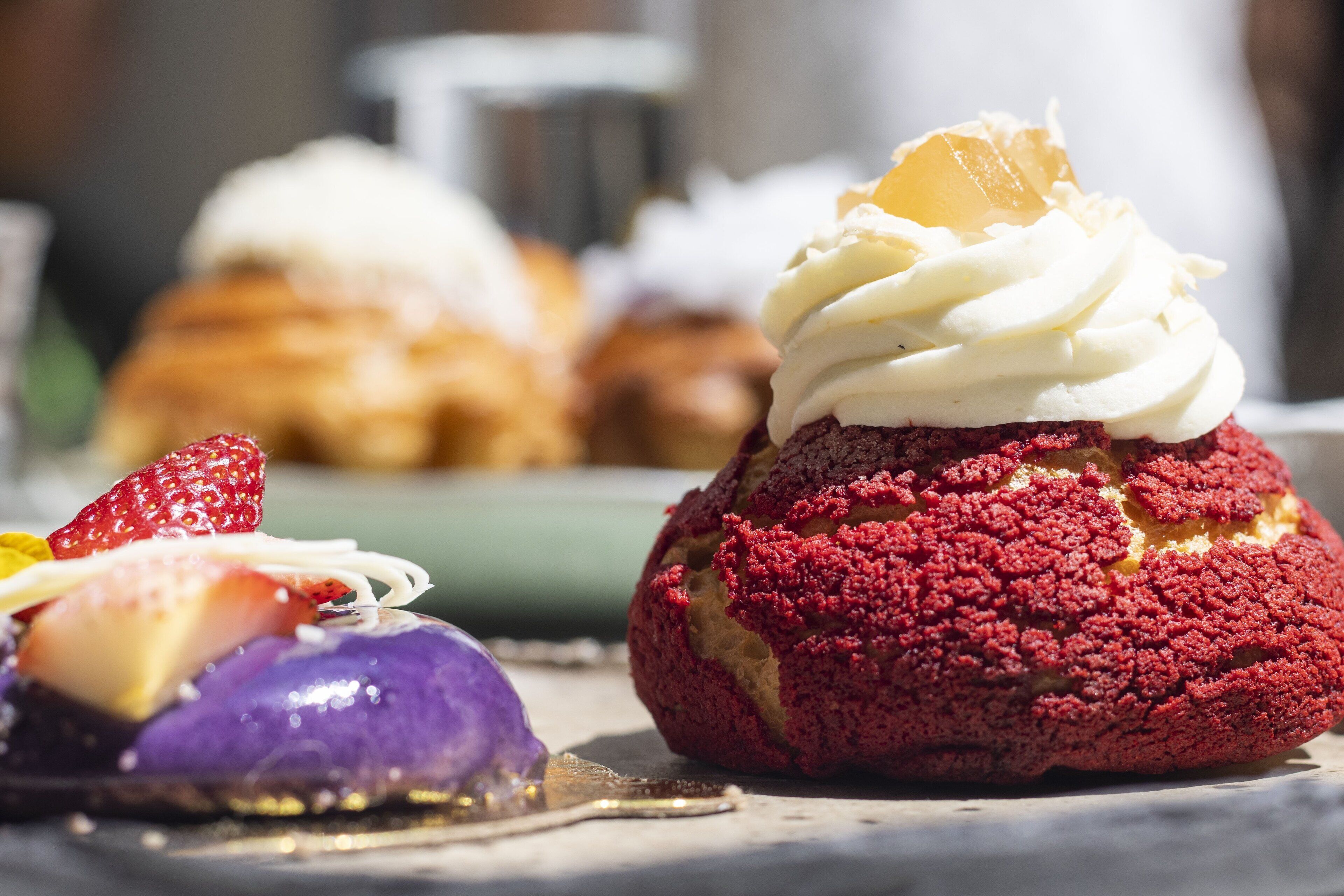A dessert with whipped cream and fruit on a plate.