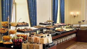 A buffet with various food items and beverages, arranged on multiple shelves and counters.