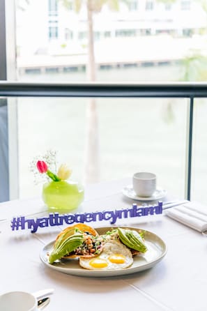 Enjoy a meal with a view at this stylish table setting, featuring a beautiful view of the surrounding cityscape.