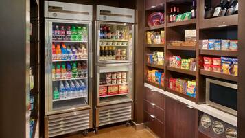 A vending area with multiple beverage dispensers and snack shelves.