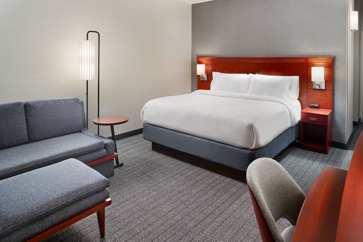 Premium bedding, desk, laptop workspace, iron/ironing board