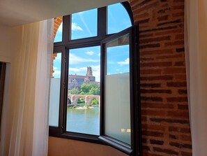 Enjoy a view of a historic landmark and a bridge over the water from this room's large window.