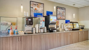 A self-service breakfast area with coffee machines, a yogurt dispenser, and a cereal bar. - Best Western Fairfax (Fairfax)