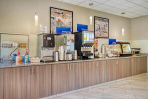 A self-service breakfast area with coffee machines, a yogurt dispenser, and a cereal bar. - Best Western Fairfax (Fairfax)