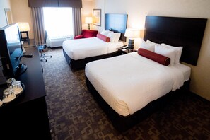A hotel room with two beds, a desk with a computer, and a TV. - Clarion Inn Elmhurst - Oak Brook near I-88, I-290, I-294 (Elmhurst)