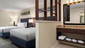 A hotel room with two beds, a large mirror, a vanity with a sink, and a towel rack. - Doubletree by Hilton Columbia, SC (Columbia)