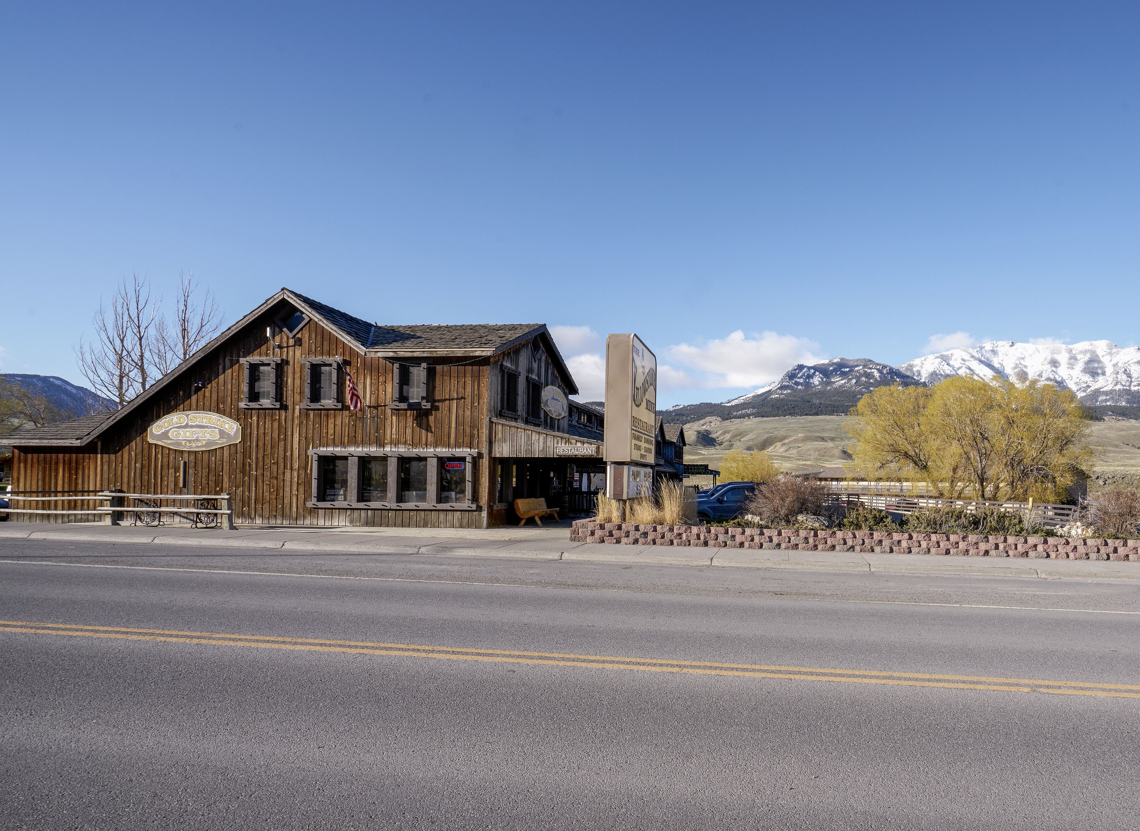 A rustic wooden building with a sign for 'Gold Star Gifts' and a restaurant.