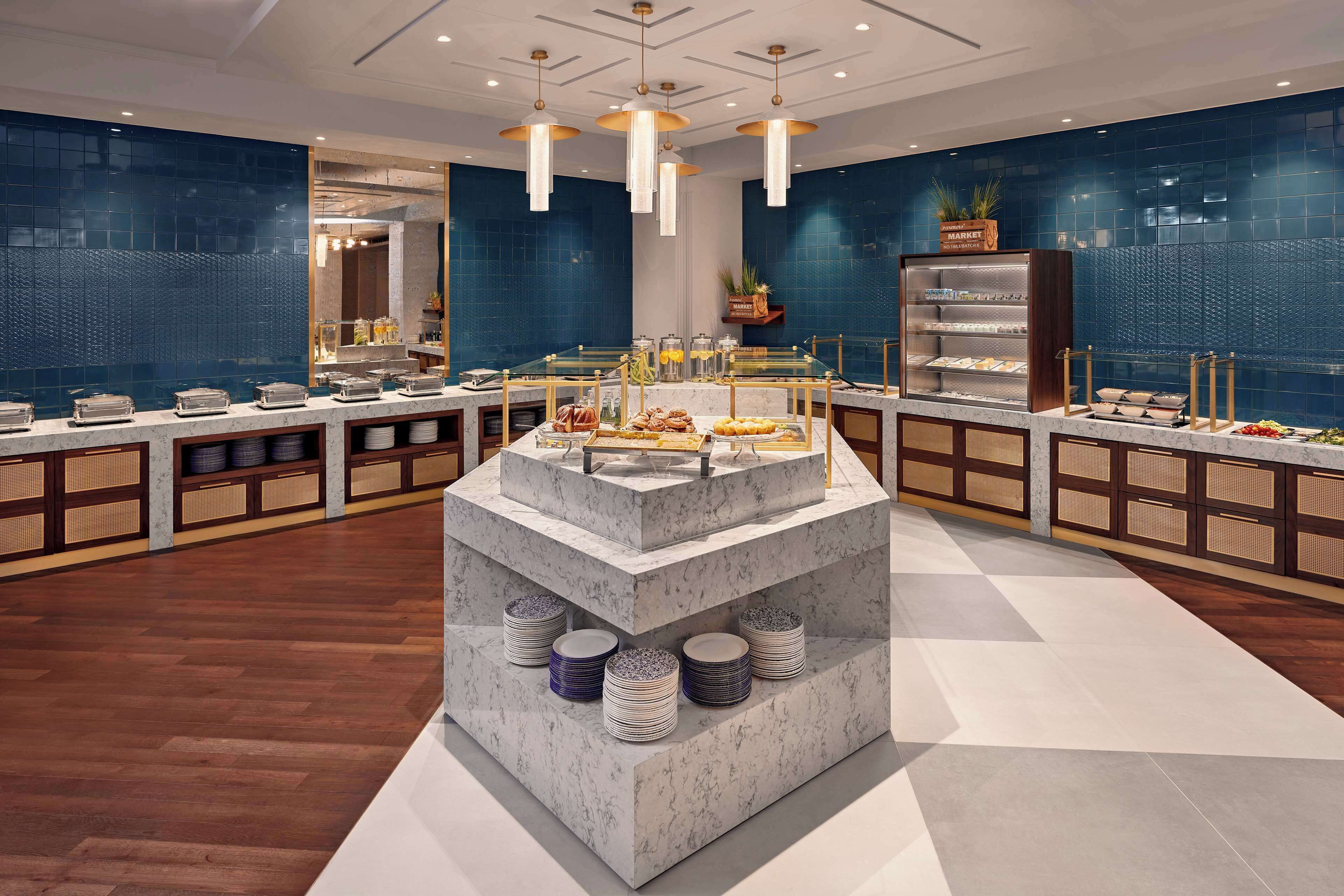 A buffet setup with multiple serving stations, a central display, and a variety of food items.