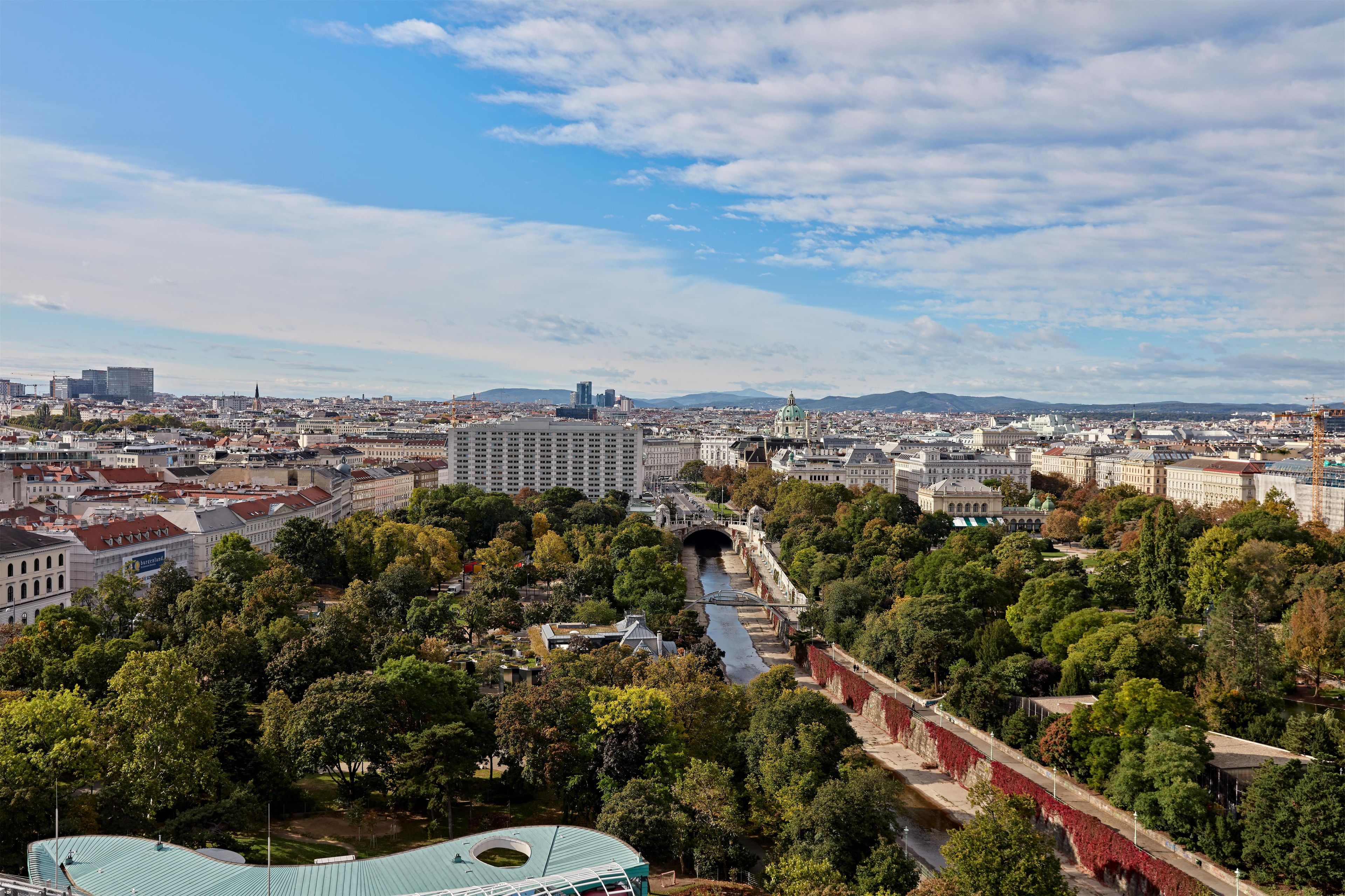 A cityscape with a river, bridges, and a mix of historical and modern buildings.