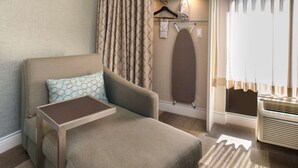 A cozy room with a sofa, a small table, a hanging board, and a radiator. - Hampton Inn Los AngelesWest Covina (West Covina)