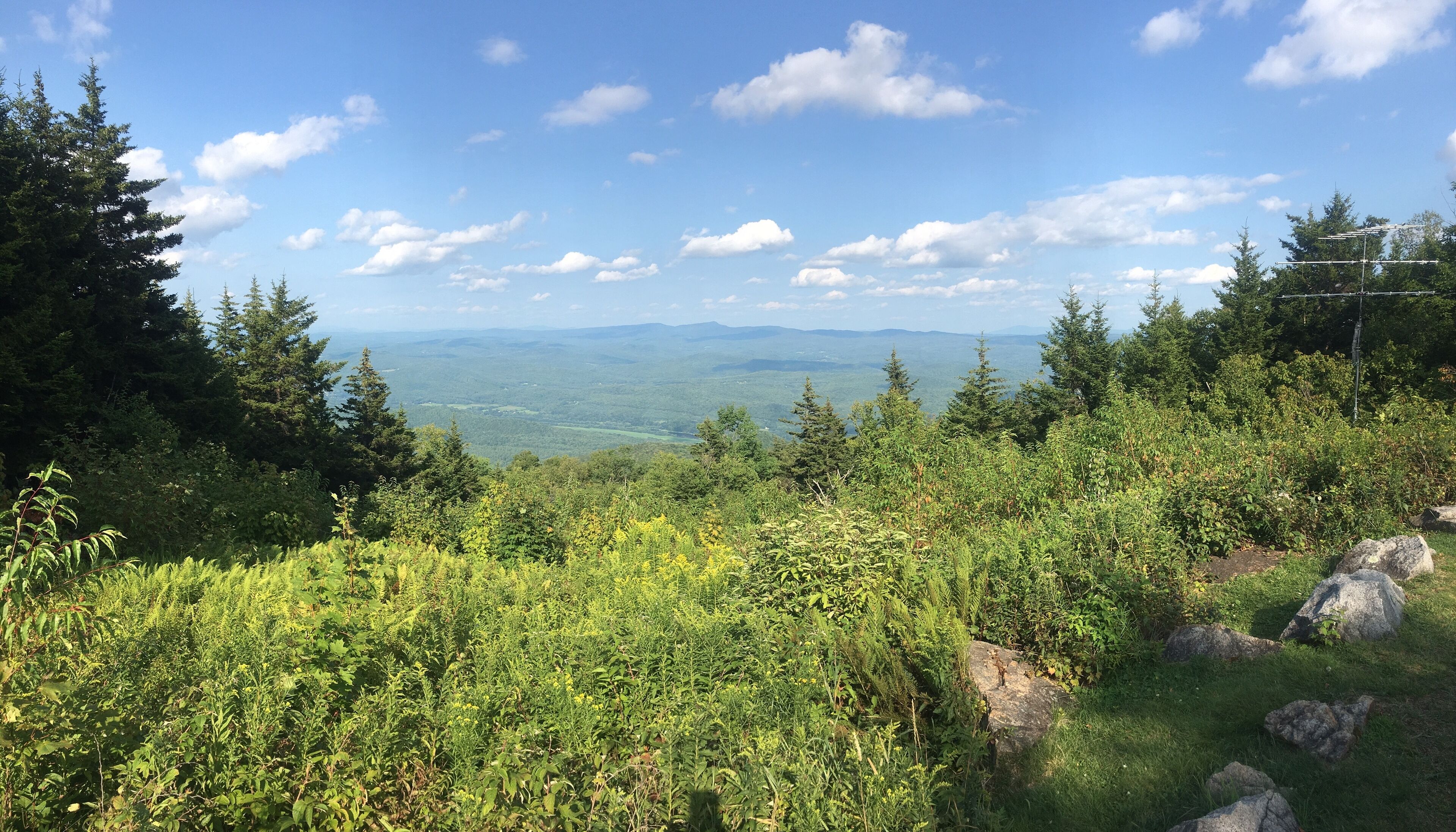 A natural landscape with a view of distant mountains and a clear sky.