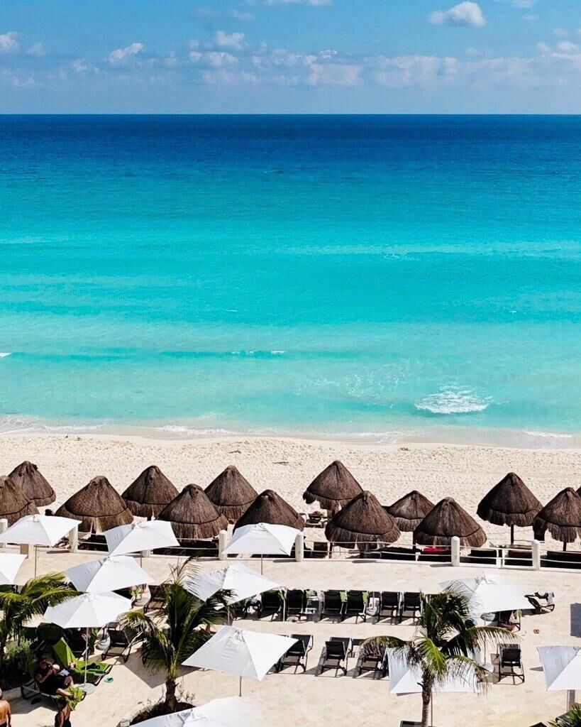 On the beach, white sand, sun loungers, beach umbrellas
