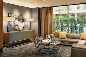 A modern living room with a sofa, a coffee table, and a cabinet.