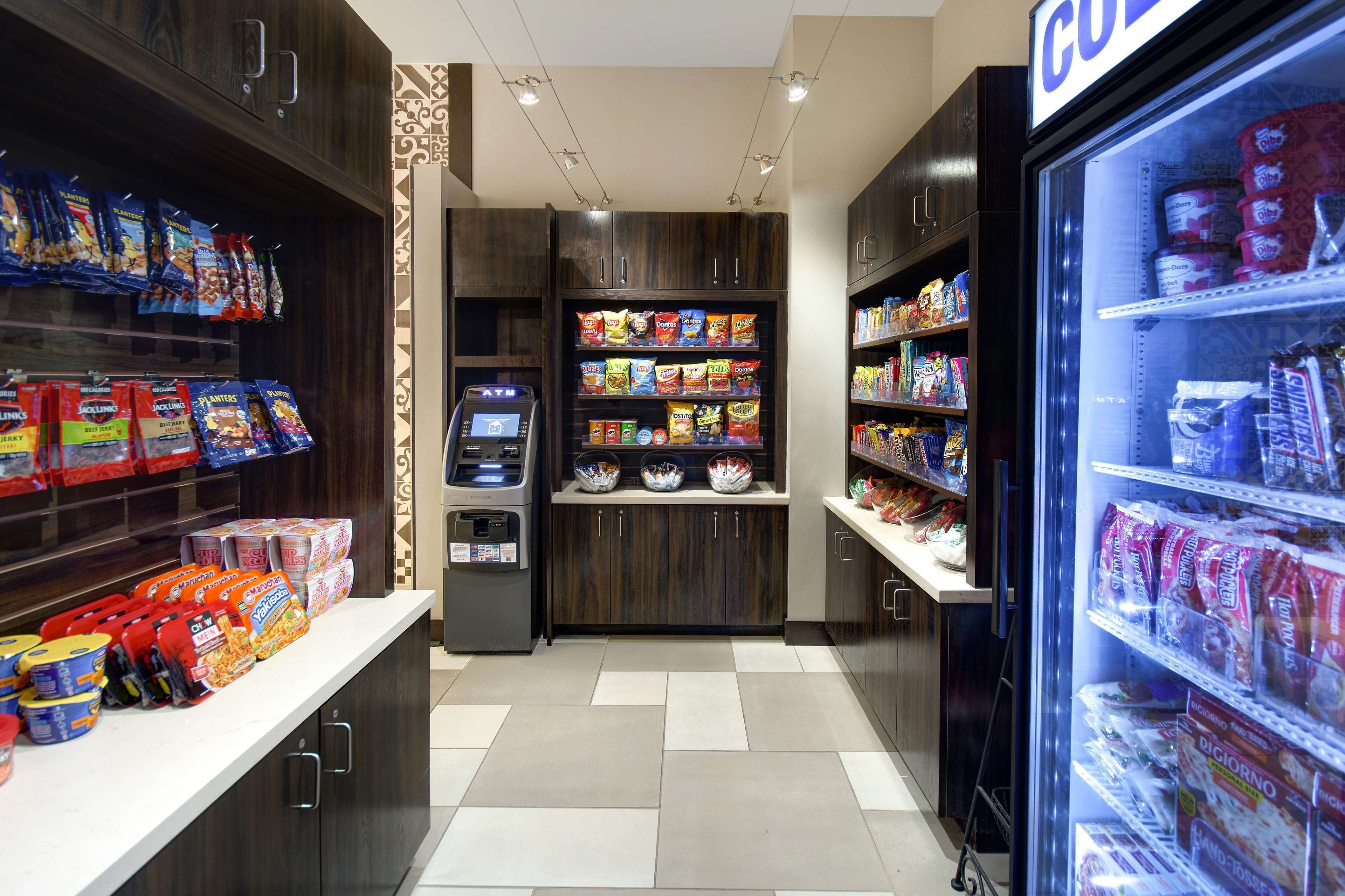 A self-service snack and beverage kiosk with various packaged snacks and drinks.