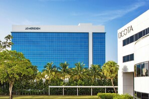 A modern building with the Meridien and DCOTA logos, surrounded by palm trees and a well-maintained lawn. - Le Méridien Dania Beach at Fort Lauderdale Airport (Dania Beach)