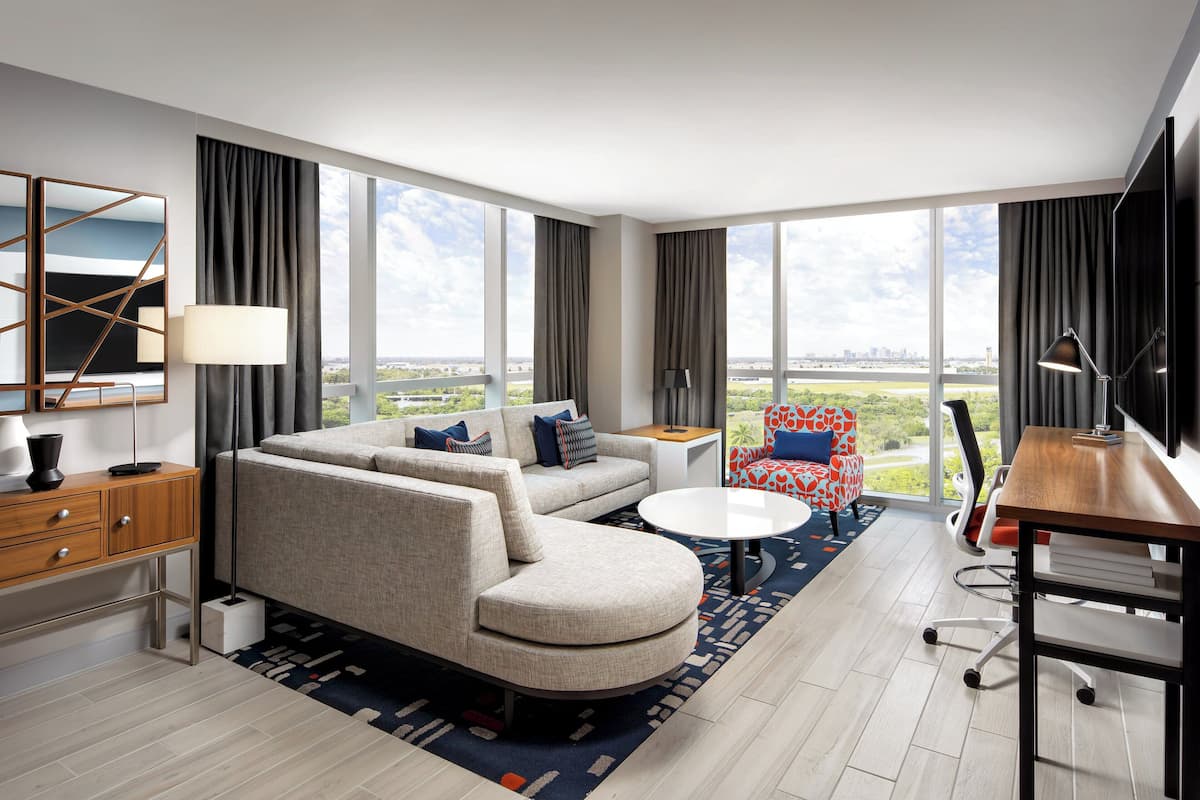 suite, 1 king bed, non smoking | living room | 65-inch plasma tv with satellite channels, tv