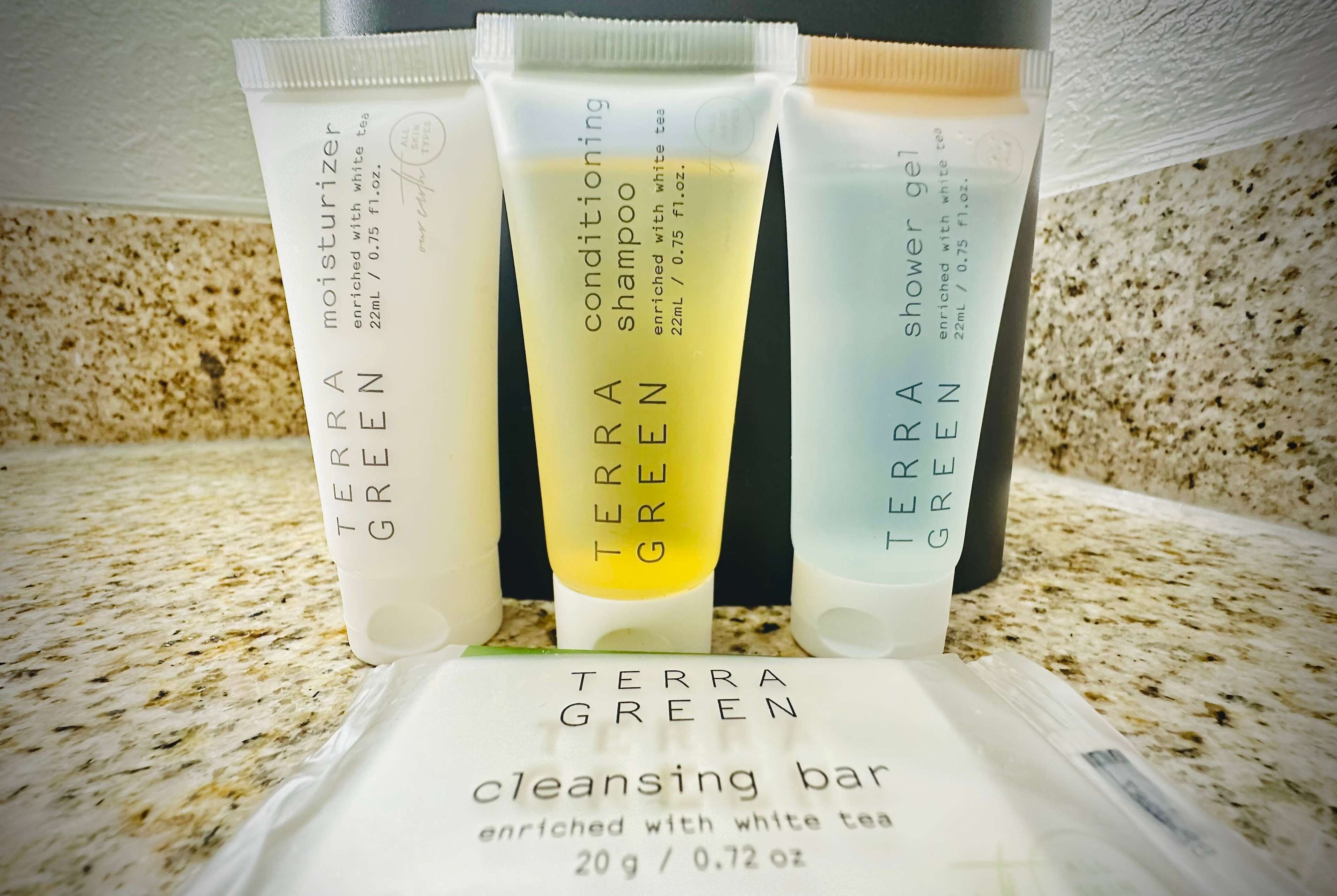 Four Terra Green product tubes on a countertop.