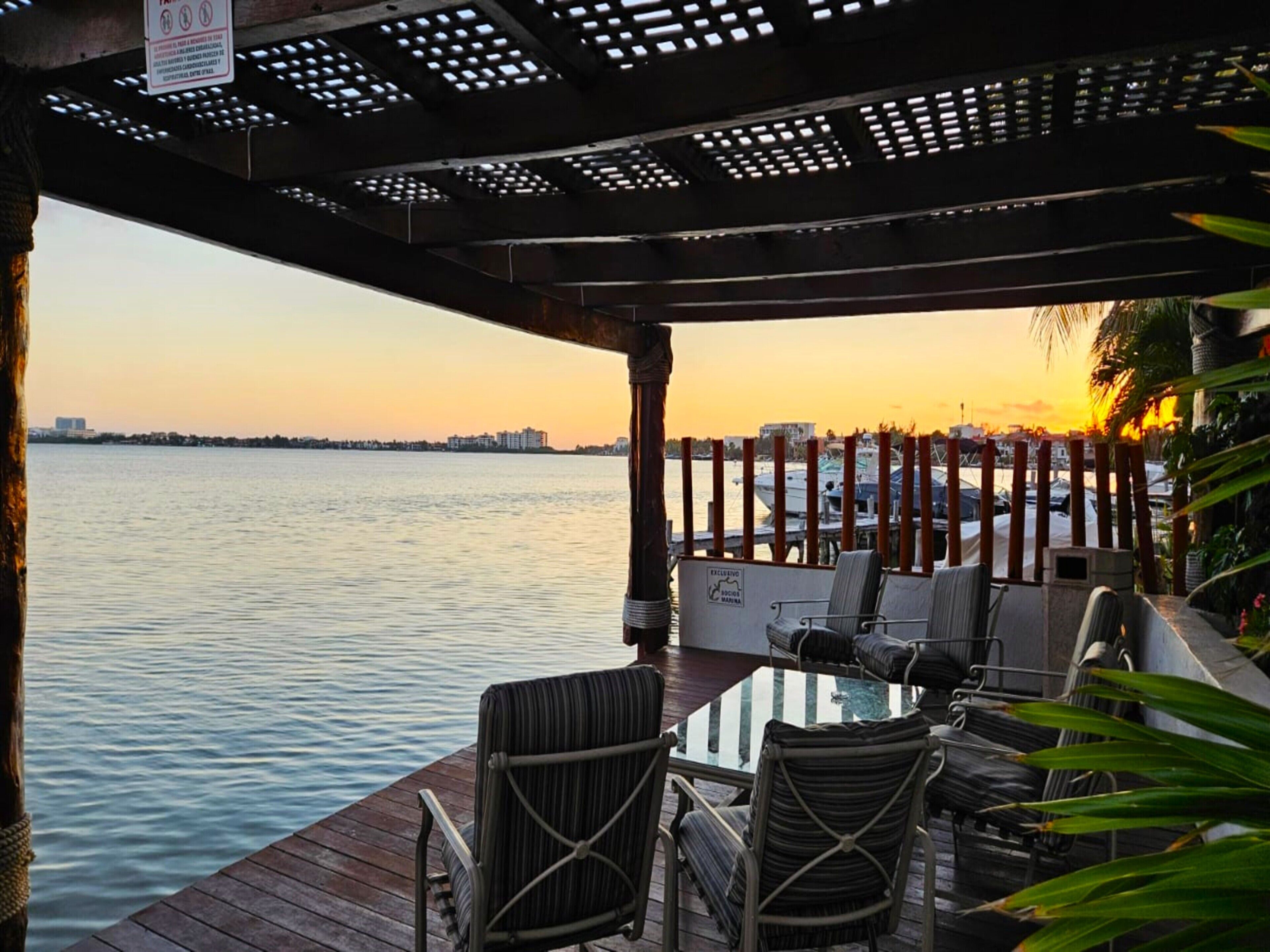 A waterfront patio with outdoor seating and a view of the water.