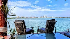 Two chairs facing a body of water with a city skyline in the background. - Sina Suites Cancún - Adults Only (Cancun)