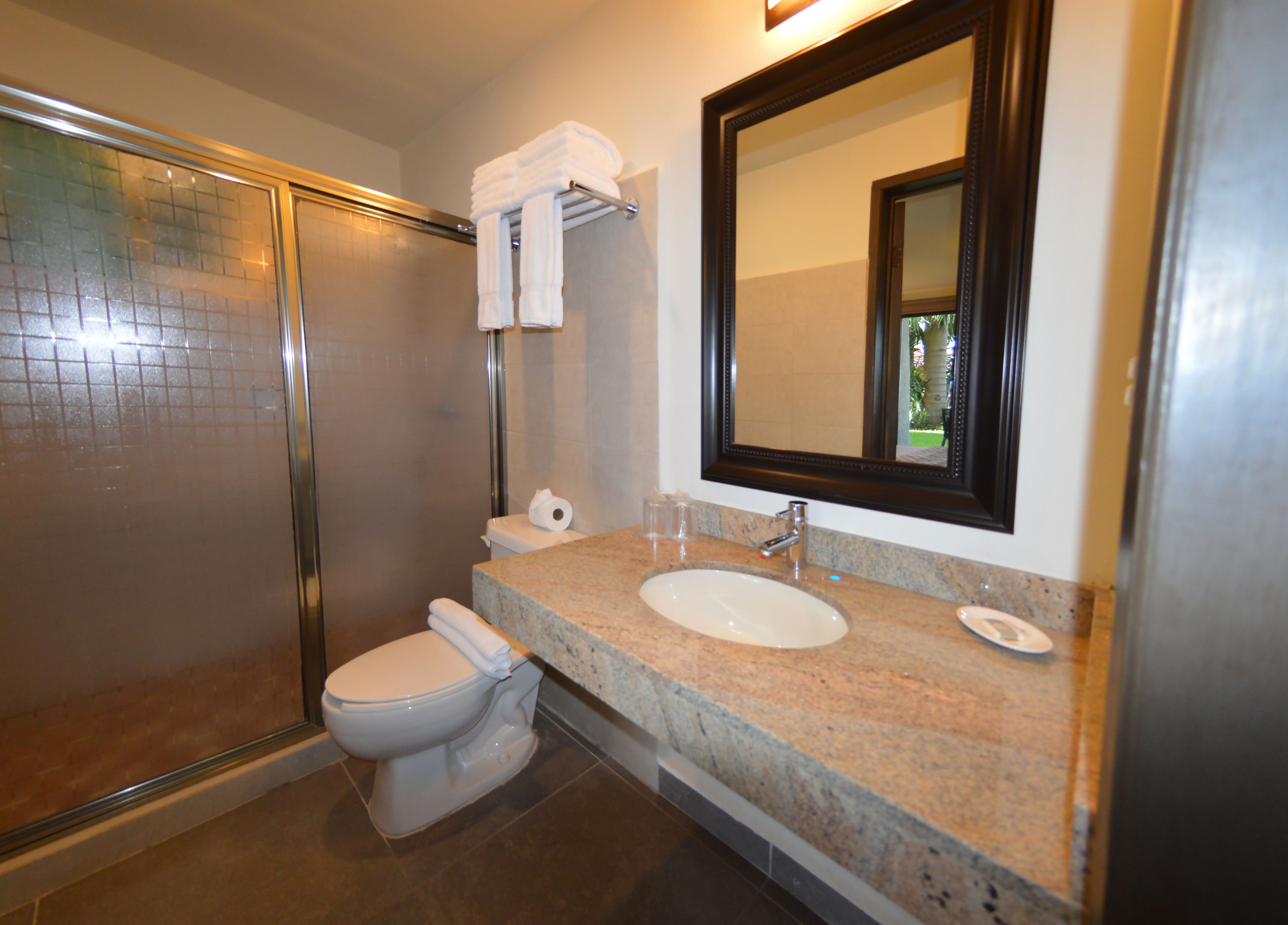 luxury junior suite lagoon view  | bathroom | shower, eco-friendly toiletries, hair dryer, towels