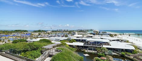 A coastal resort with multiple buildings, a boardwalk, and a beach area.