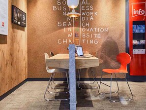 A modern workspace with a wooden table, metal chairs, and a laptop. - ibis Toulon La Seyne Sur Mer (La Seyne-sur-Mer)