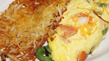 A plate with hash browns and an omelette.