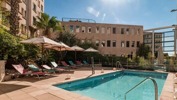 Seasonal outdoor pool, open 9:00 AM to 8:00 PM, pool umbrellas