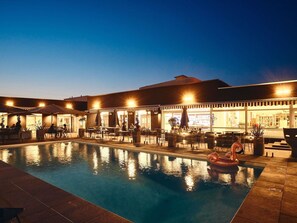 Seasonal outdoor pool, open 9:00 AM to 10:00 PM, pool umbrellas
