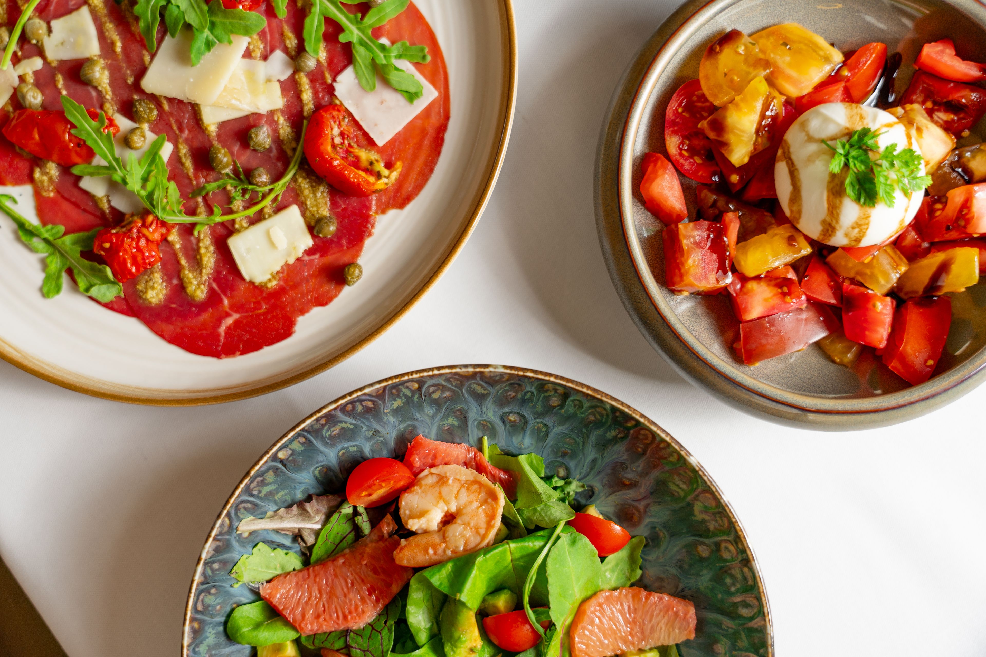 Three plates of food with various ingredients.