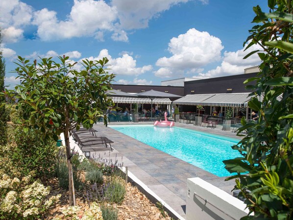 Seasonal outdoor pool, open 9:00 AM to 10:00 PM, pool umbrellas