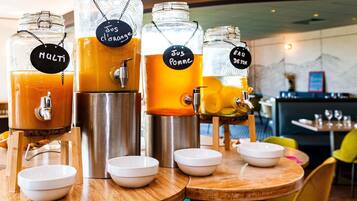 A beverage station with labeled dispensers and bowls for serving.