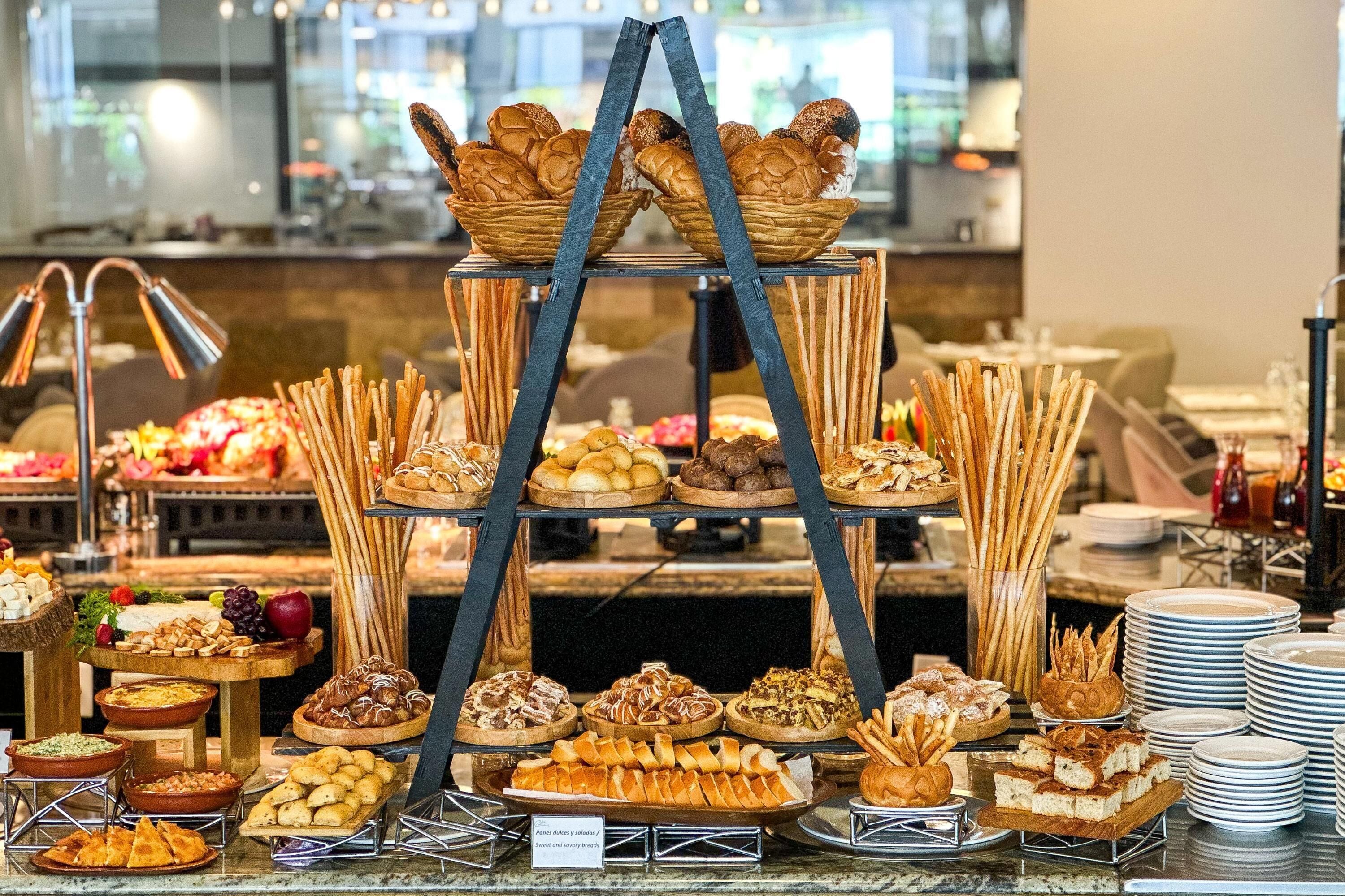 A buffet with various food items arranged on multiple tiers.
