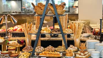 A buffet with various food items arranged on multiple tiers.
