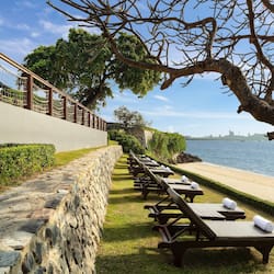 Relax in style with a view of the calm sea and city skyline from our beachfront lounge chairs.