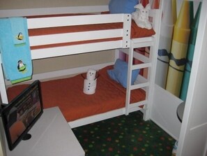A bunk bed room with a small desk and a colorful polka dot floor. - Holiday Inn Resort Lake George - Adirondack Area by IHG (Lake George)