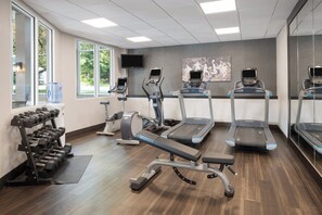 A gym with treadmills, elliptical machines, and a dumbbell rack. - Holiday Inn Resort Lake George - Adirondack Area by IHG (Lake George)