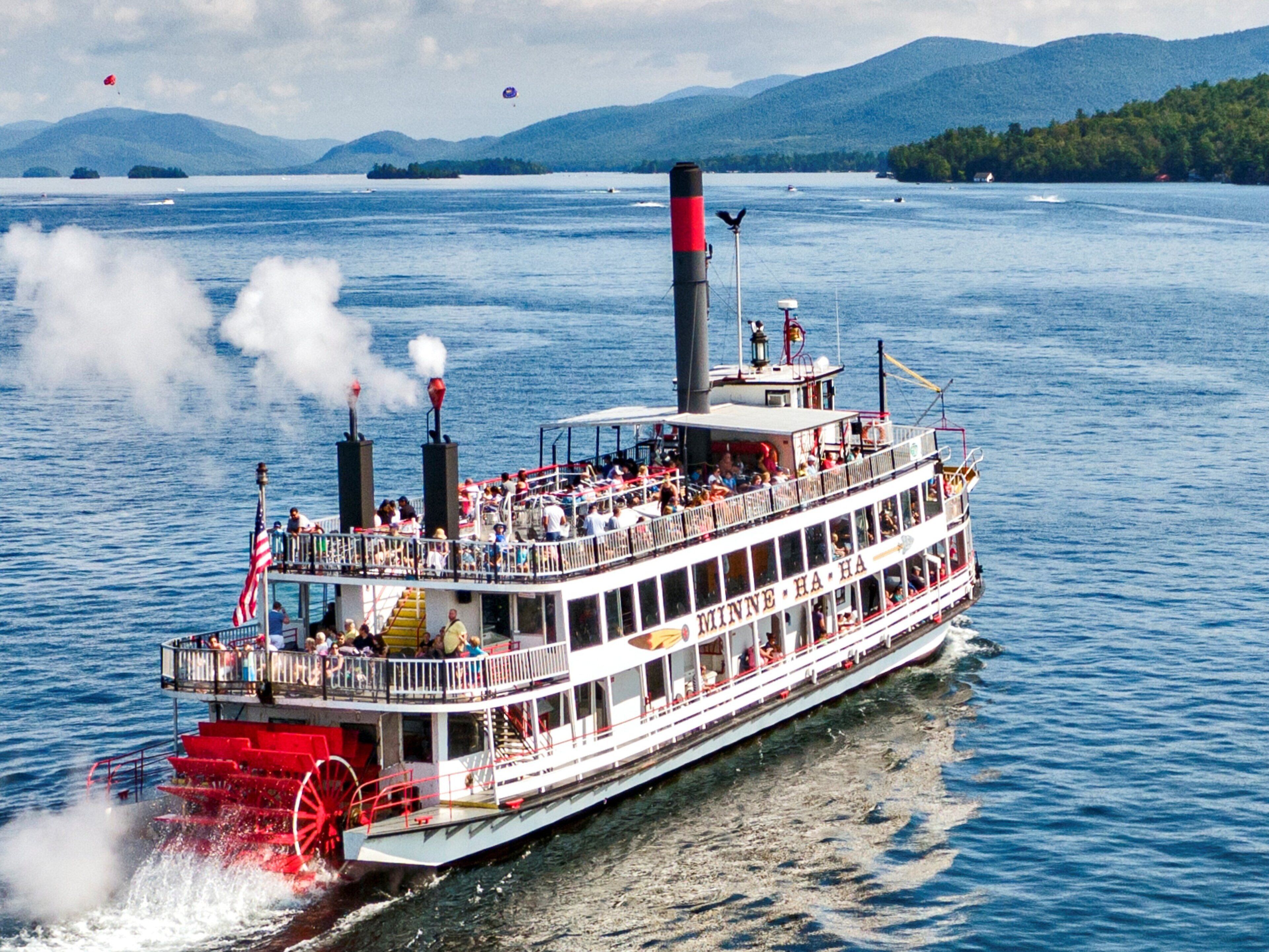 A riverboat with multiple decks, passengers, and a prominent smokestack.