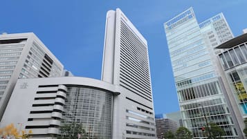 A modern hotel with a curved facade and multiple floors.
