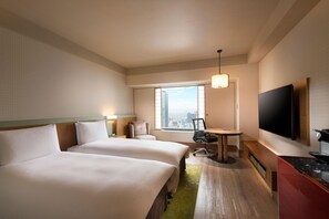 A hotel room with two beds, a desk, a chair, a TV, and a window with a city view. - Hilton Osaka (Osaka)